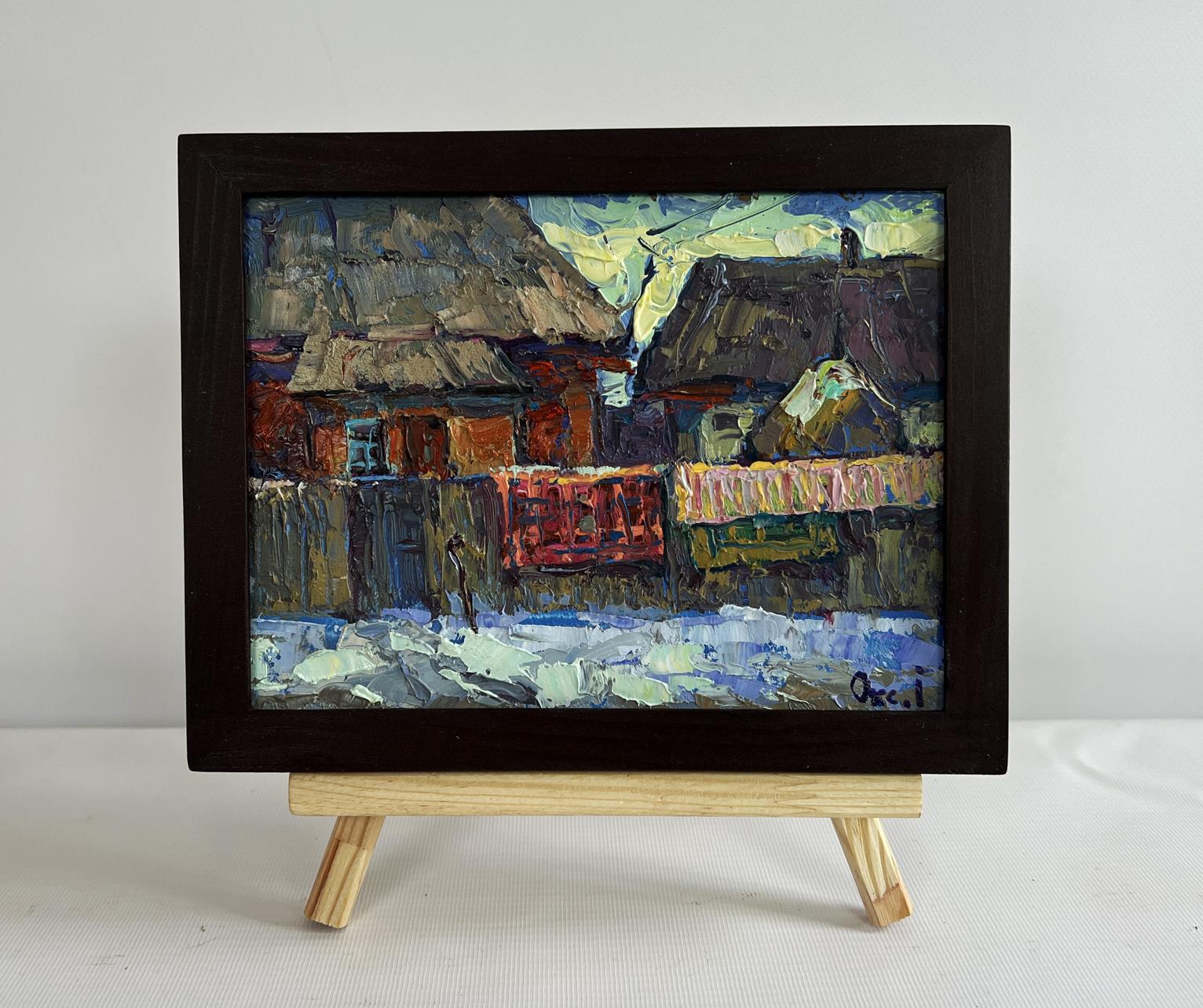Oil painting of sunset behind rustic snow village rooftops by Oksana Ivanyuk