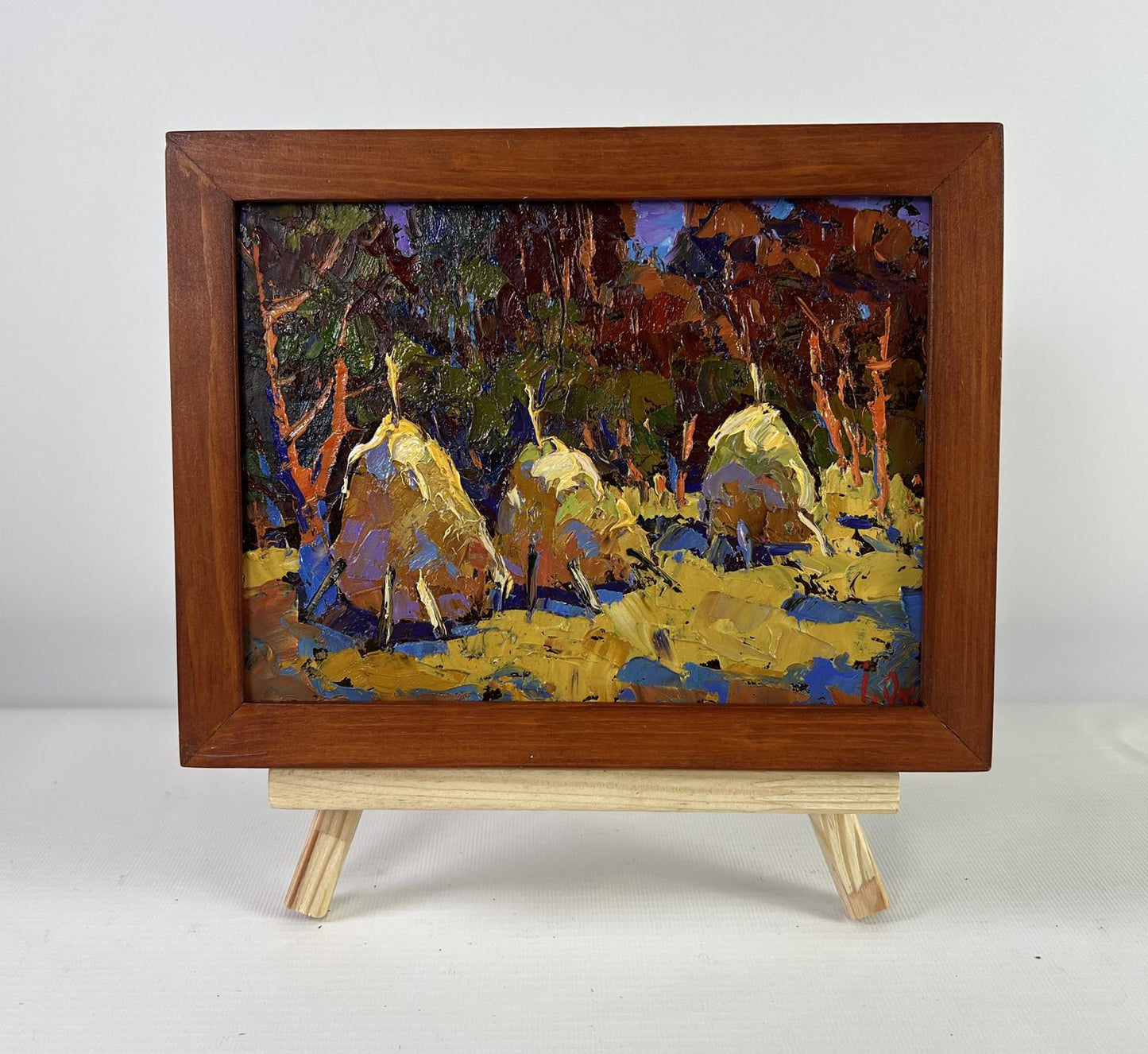 Oil painting Autumn Silence by Oksana Ivanyuk: forest with golden haystacks