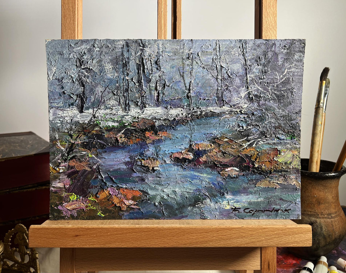 Oil painting Magical Winter by Boris Serdyuk: snowy forest stream with autumn leaves