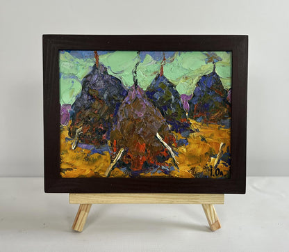 Oil painting of haystacks on golden field with purple green mountains by Oleksiy Ivanyuk