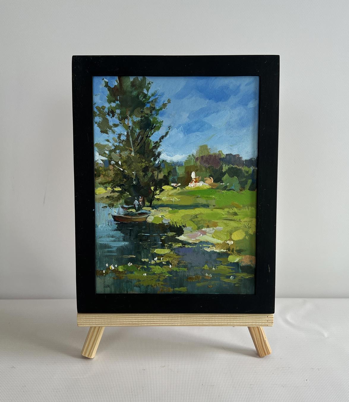 Black-framed oil painting of boat by lonely tree on serene lakeside by Yuriy Suprunchuk