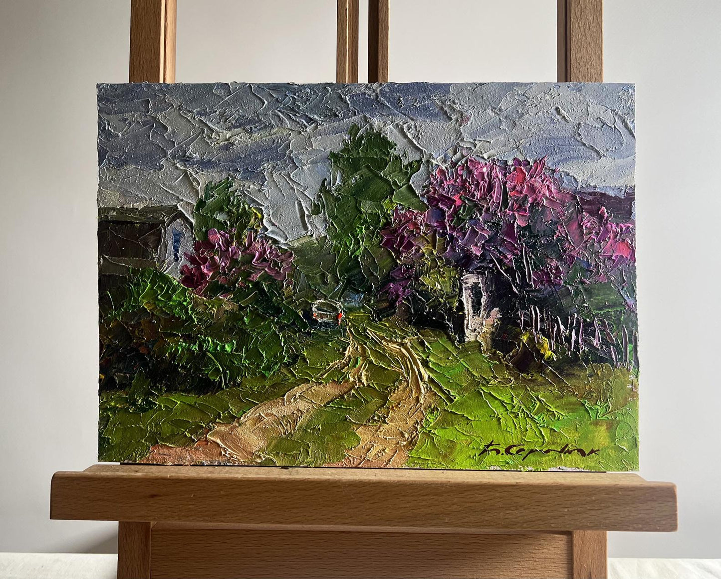 Oil painting Lilac growing in village by Boris Serdyuk on easel