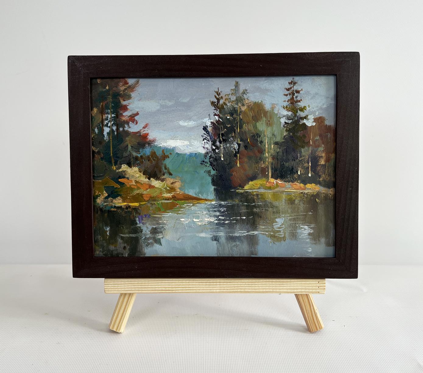Oil painting of river in autumn forest by Yuriy Suprunchuk on wooden easel