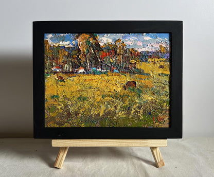 Oil painting of yellow autumn meadows by Oksana Ivanyuk in black frame