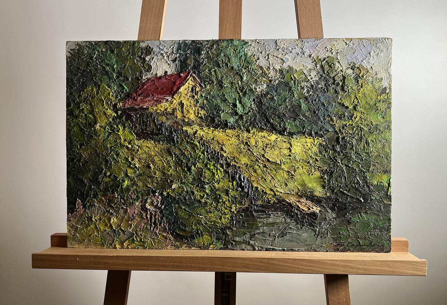 Oil painting of Boris Serdyuk house near pond on wooden easel