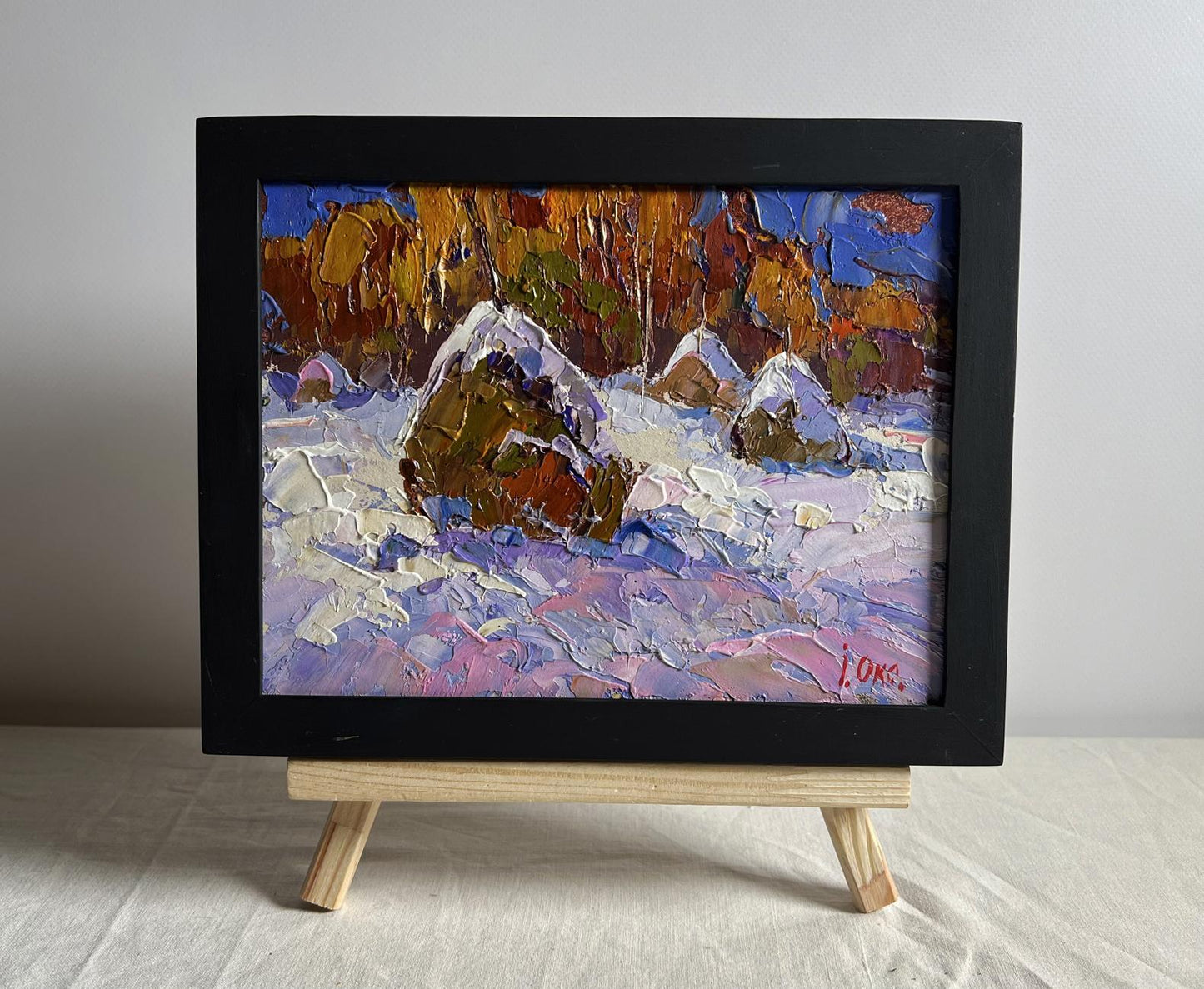 Oil painting Winter night in nature by Oksana Ivanyuk in black frame on easel