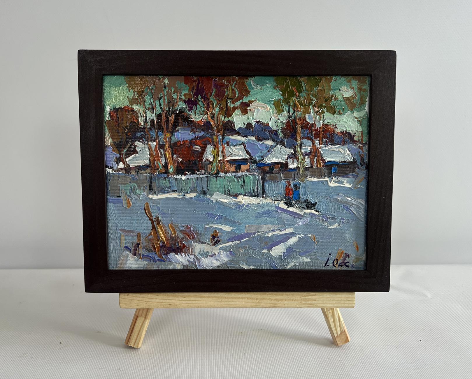 Oil painting of snowy village by Oksana Ivanyuk in dark wood frame