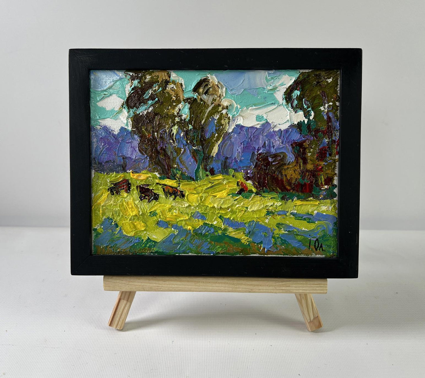 Oil painting At the Source by Oleksiy Ivanyuk: bison in yellow field, teal sky