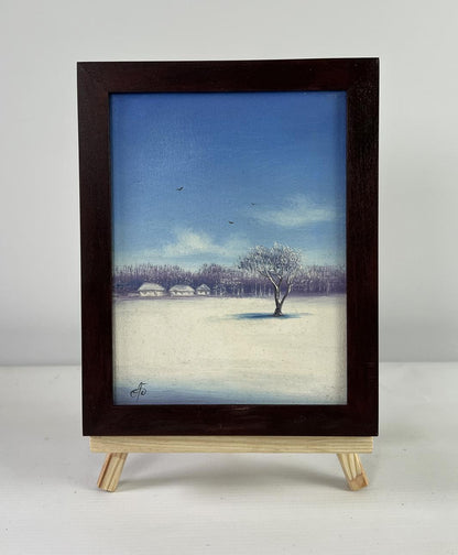 Dark wooden-framed oil painting of snowy winter landscape at dawn by Andrei Bagno