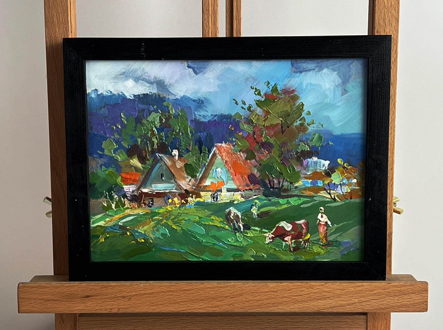 Vibrant impressionist oil painting by Yuriy Suprunchuk of cows grazing in village, framed in black