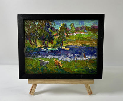 Oil painting Near the river by Oksana Ivanyuk, cows grazing by river in frame