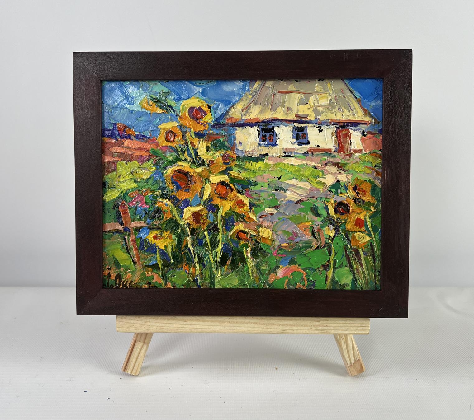 Oil painting The sun in every sunflower by Oksana Ivanyuk in dark frame on easel