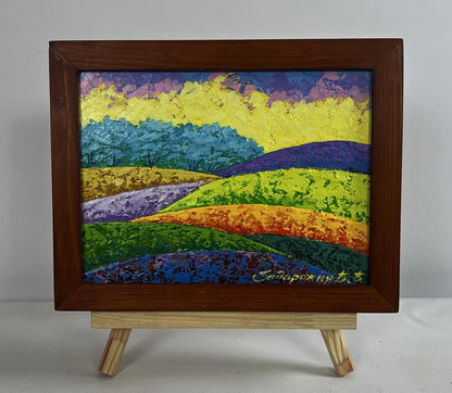 Vibrant textured oil painting of fiery sky over green forest by V. Zadorozhnya in wooden frame