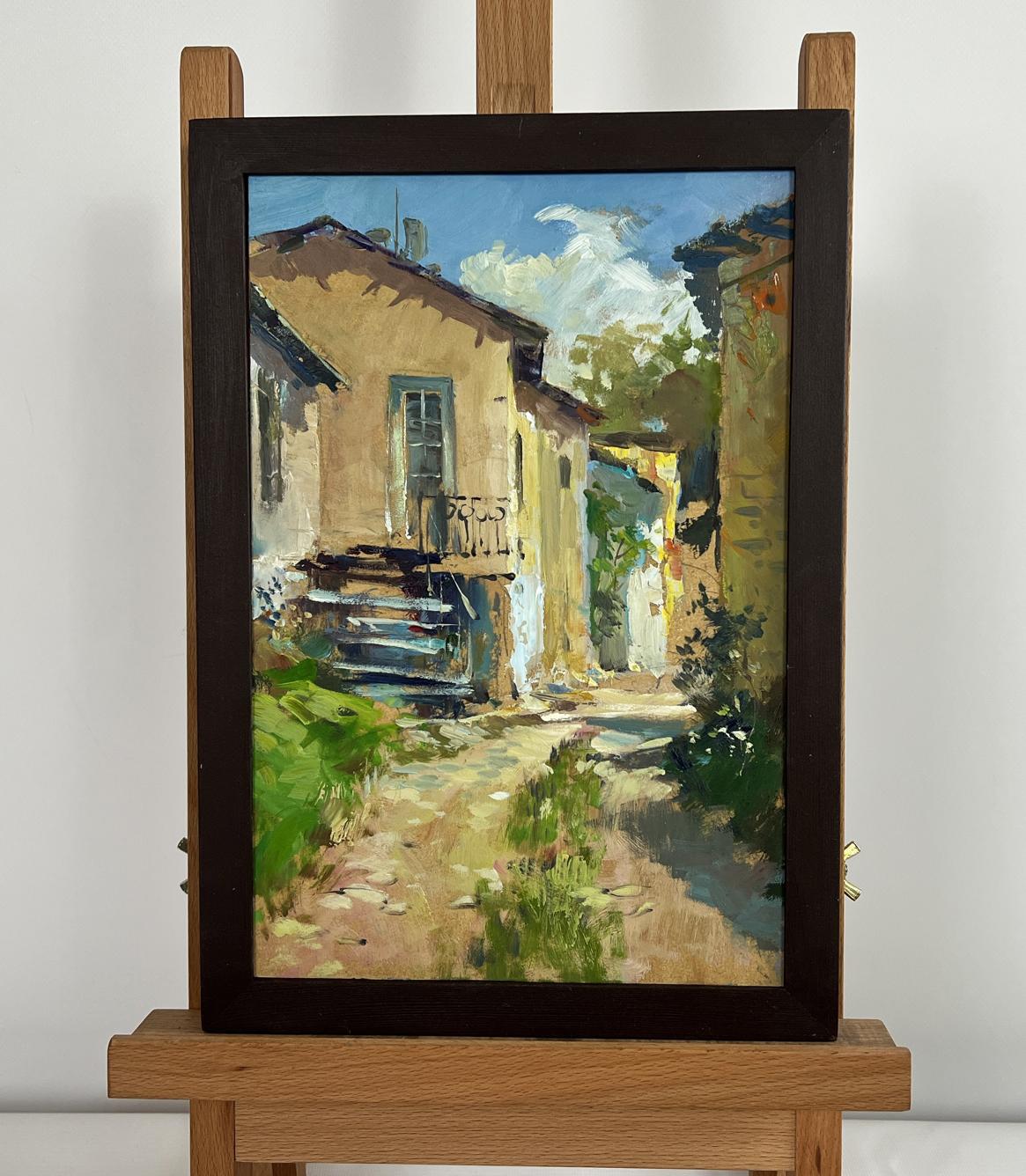 Framed oil painting by Yuriy Suprunchuk: sunlit summer city courtyard alley