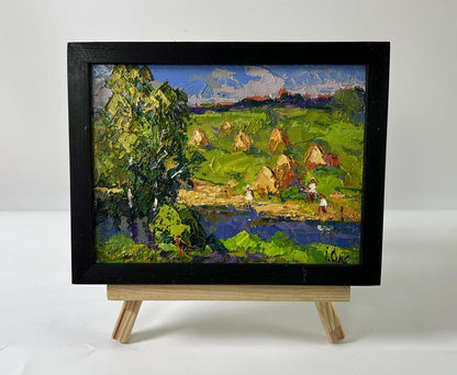 Oil painting Haystacks by the River by Oksana Ivanyuk in black frame