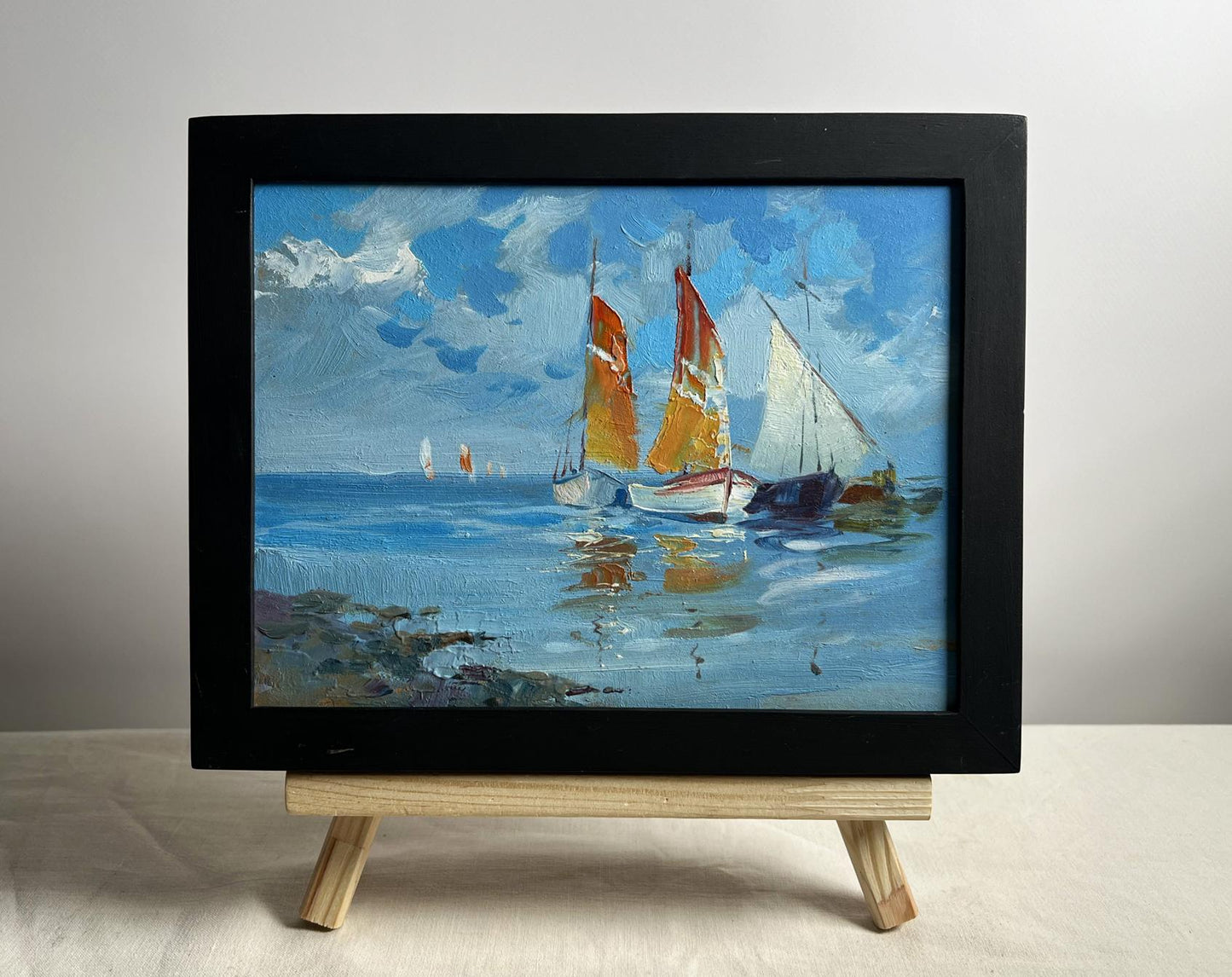 Framed oil painting On a Journey by Sea by Yuriy Suprunchuk on easel