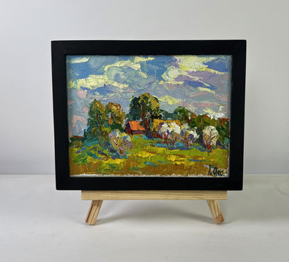 Oil painting by Oksana Ivanyuk: Clouds drifting in vibrant green fields, framed