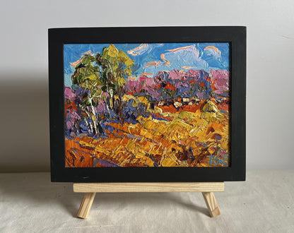 Oil painting Golden autumn field by Oksana Ivanyuk in black frame on easel