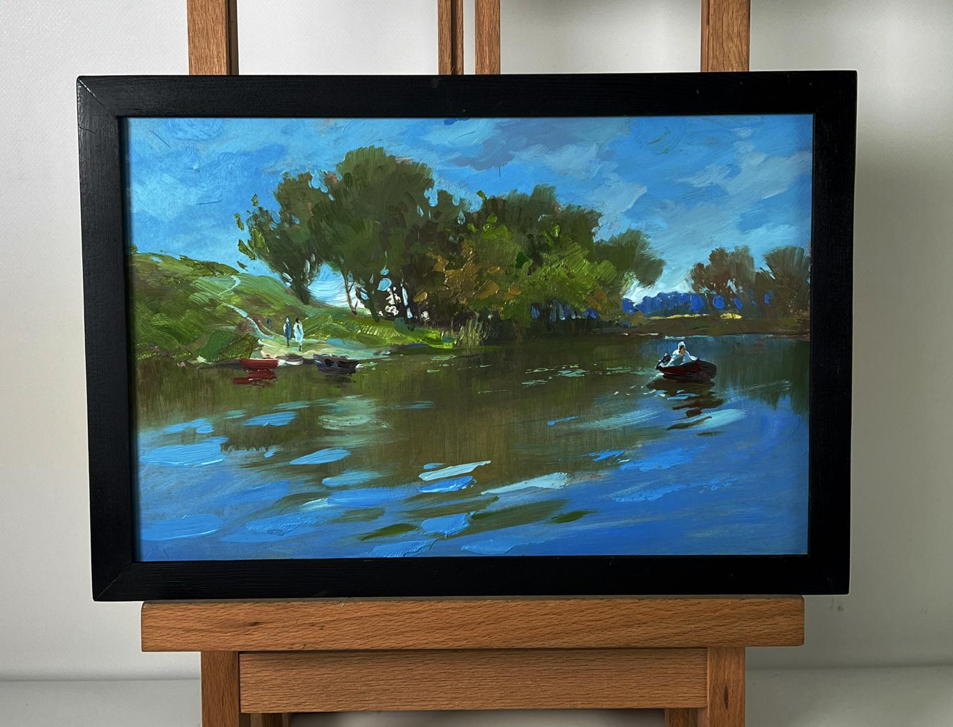 Framed oil painting by Yuriy Suprunchuk of serene lakeside boats in river