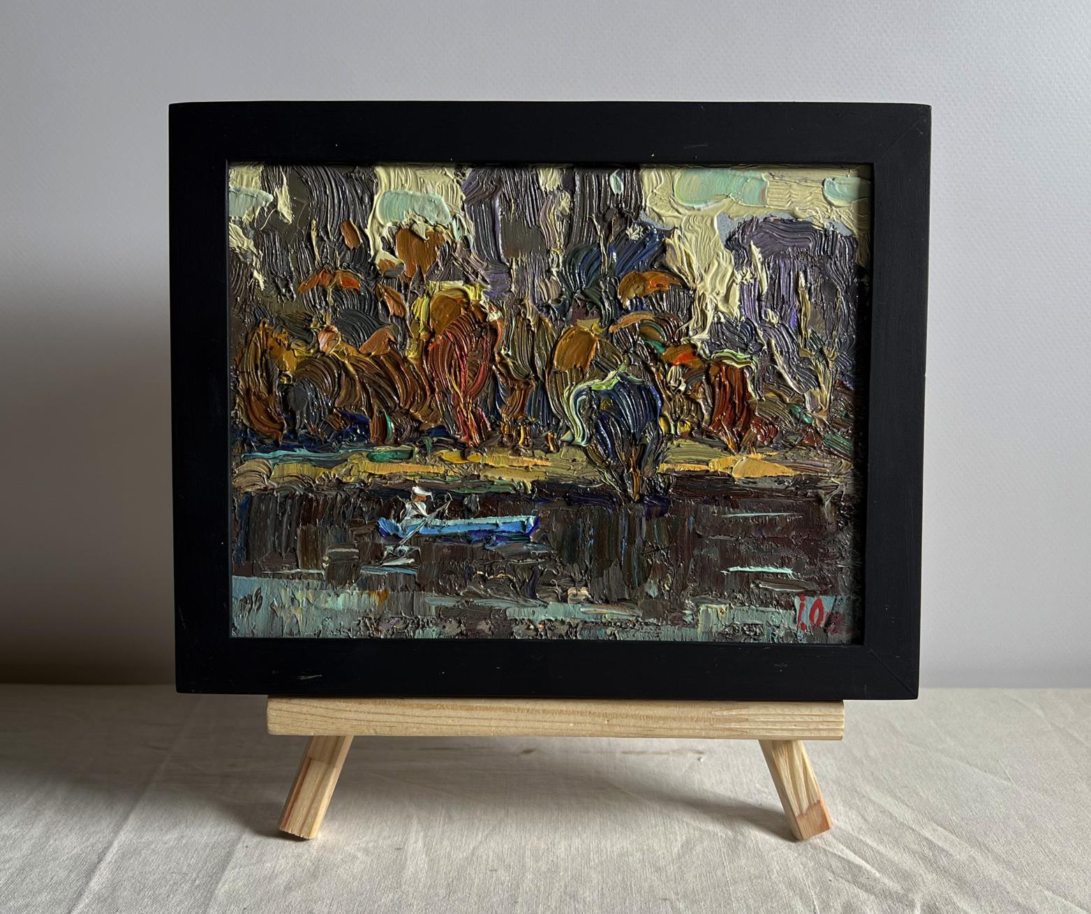 Oil painting Deep into the forest across the river by Oleksiy Ivanyuk in black frame on easel