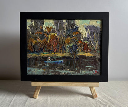 Oil painting Deep into the forest across the river by Oleksiy Ivanyuk in black frame on easel