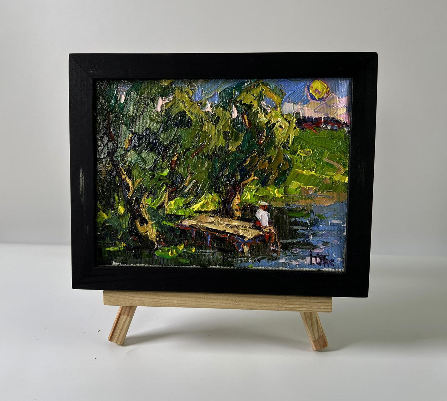 Black-framed miniature oil painting The coast at sunset by Oksana Ivanyuk