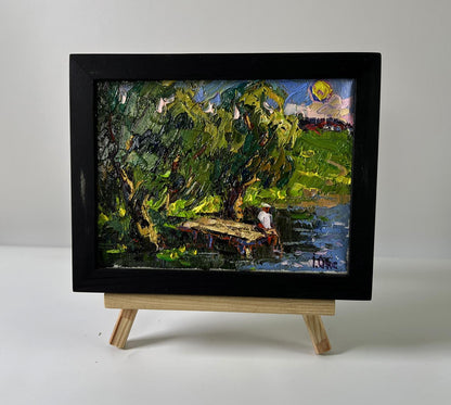 Black-framed miniature oil painting The coast at sunset by Oksana Ivanyuk