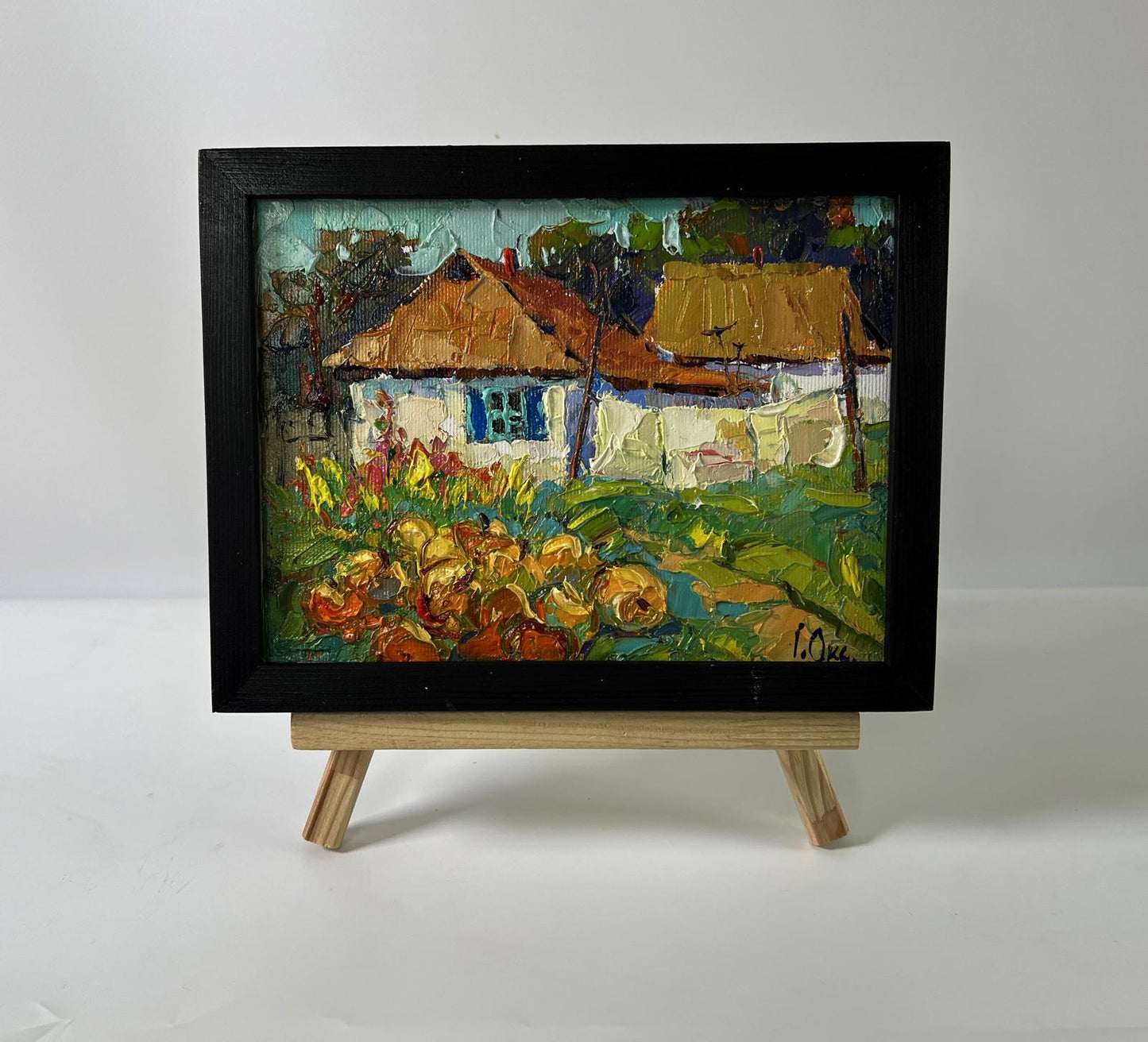 Oil painting of village courtyard by Oksana Ivanyuk in black frame