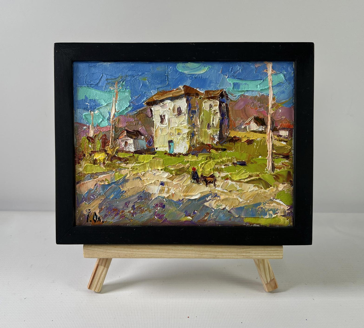 Oil painting Eastern motif by Oleksiy Ivanyuk, vibrant rustic village scene on easel