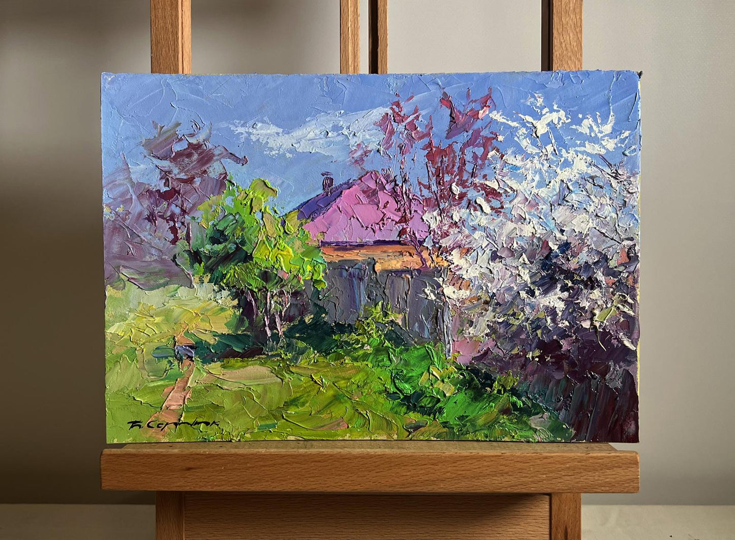 Oil painting Cherry blossom Boris Serdyuk: rustic house with pink roof in lush greenery