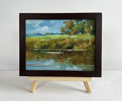 Oil painting Enjoying the natural silence by Yuriy Suprunchuk, serene river scene in frame