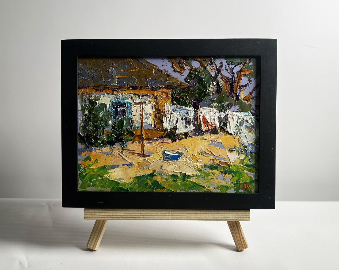 Oil painting by Oleksiy Ivanyuk: clothes drying in yard, impasto rustic scene