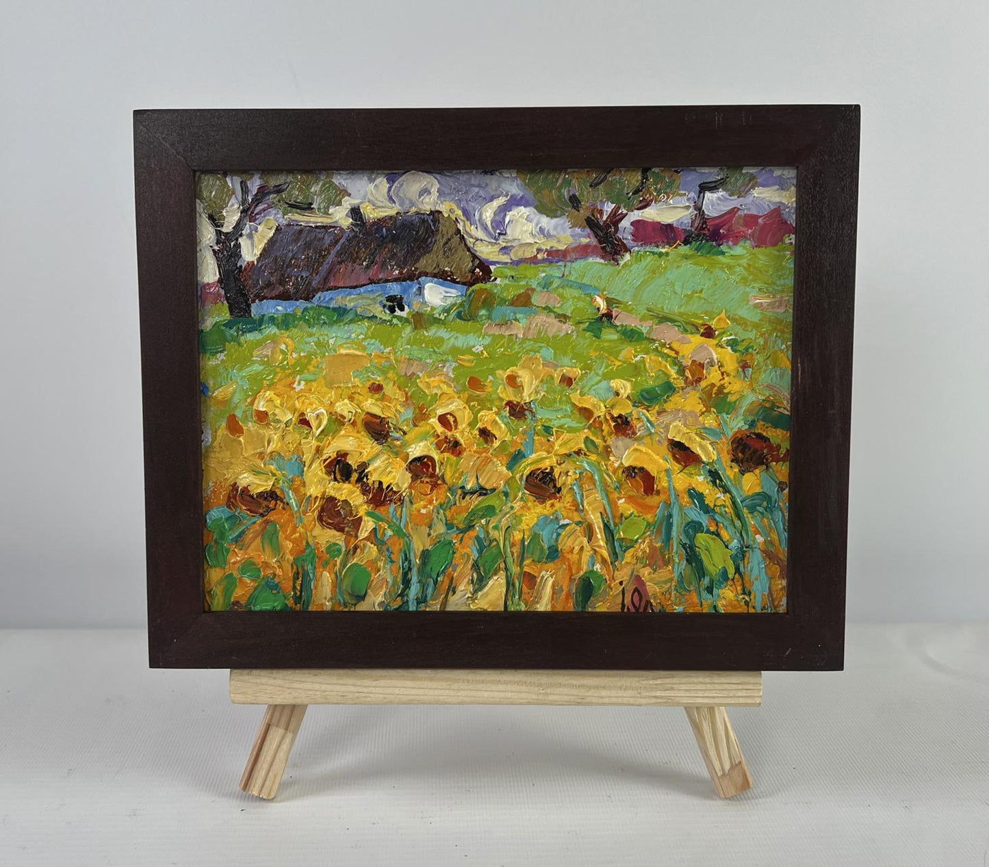 Vibrant impressionist sunflower field oil painting by Oleksiy Ivanyuk on easel
