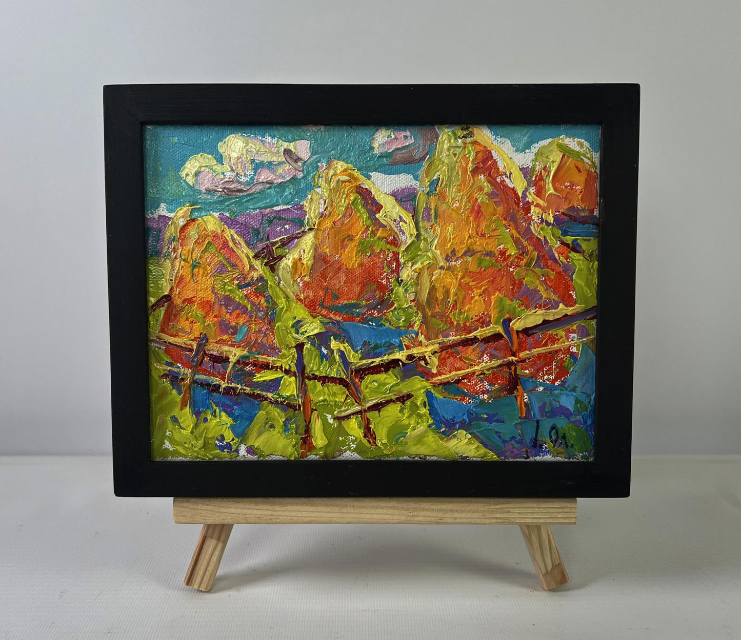 Vibrant oil painting of colorful mountains by Oleksiy Ivanyuk in black frame