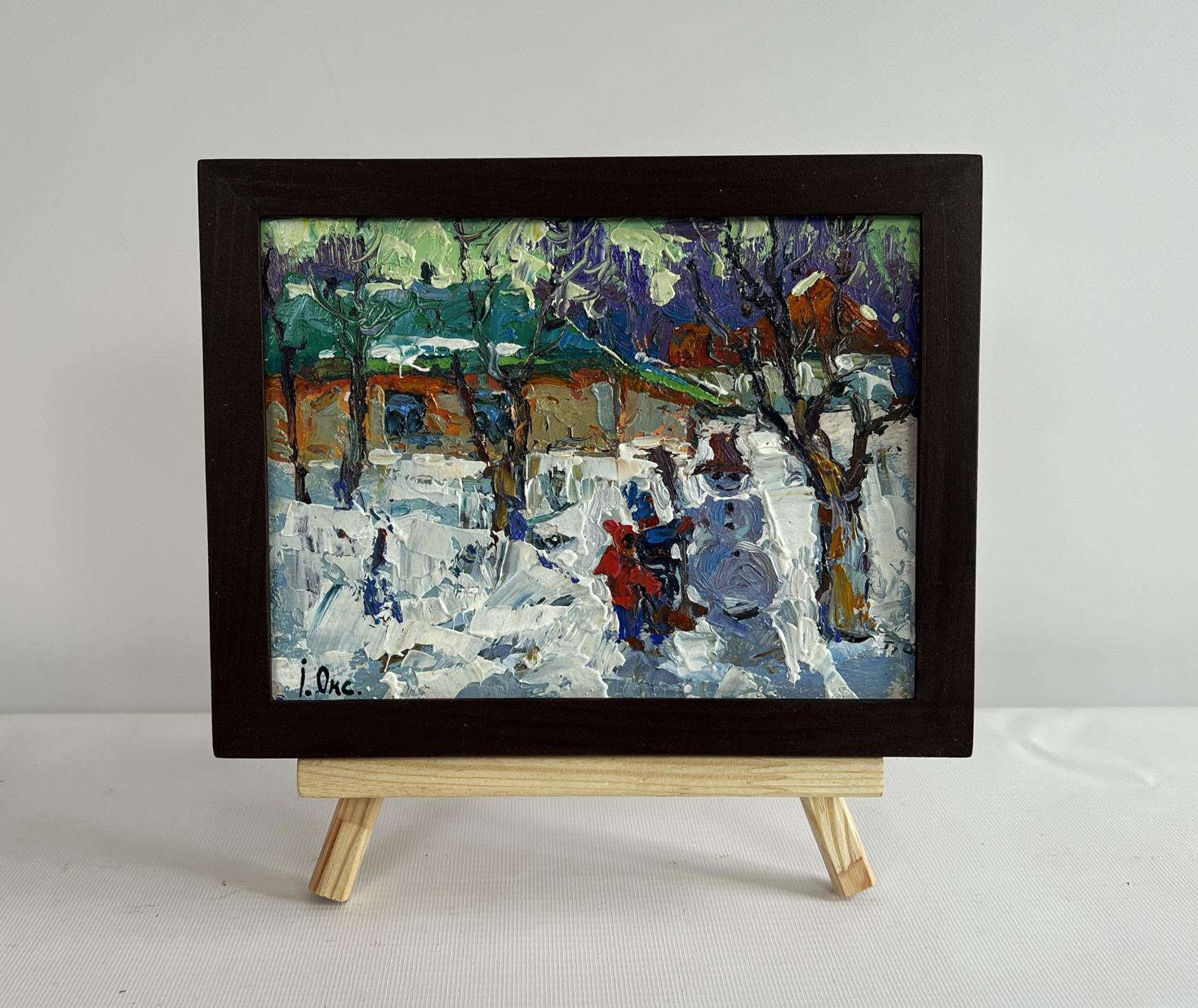 Framed oil painting by Oksana Ivanyuk of children making snowman in snow