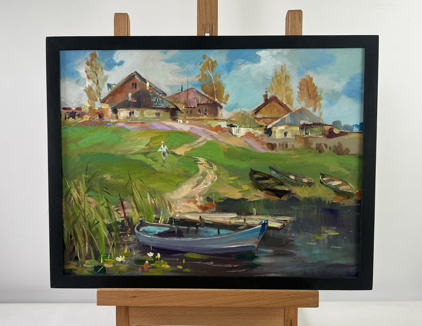 Framed oil painting of rural village with boats by Yuriy Suprunchuk
