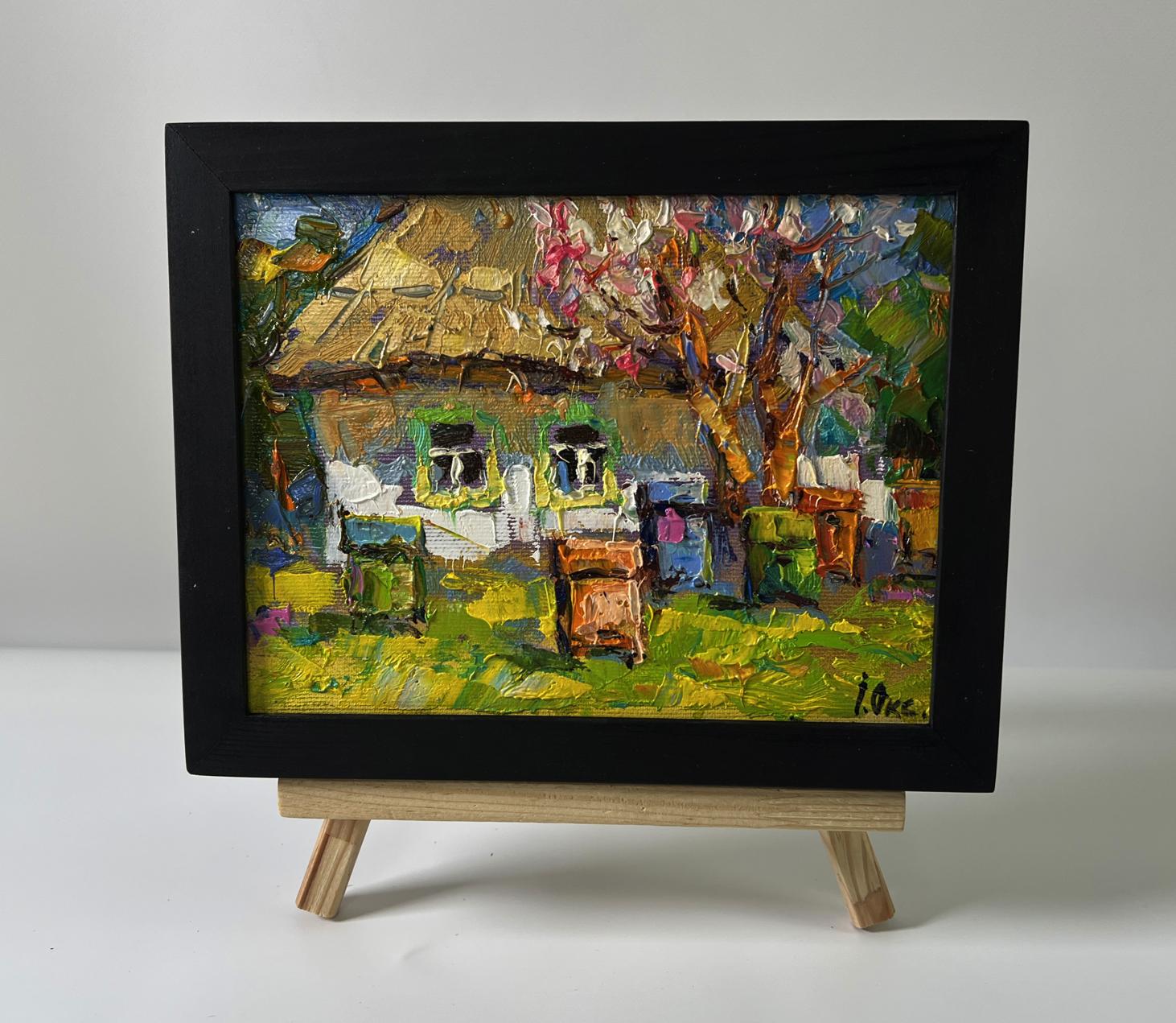 Oil painting House in the village by Oksana Ivanyuk in black frame on easel