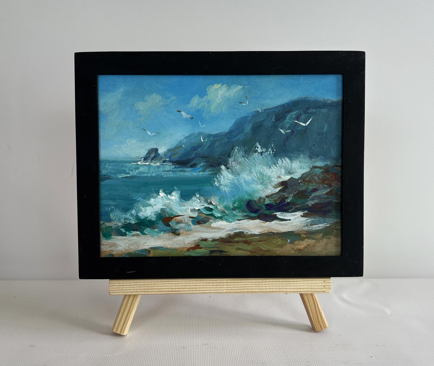 Oil painting by Yuriy Suprunchuk: sea waves crashing on rocks on wooden easel