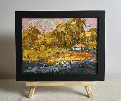 Oil painting of splashing ducklings by Oksana Ivanyuk in black frame
