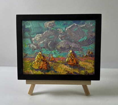 Oil painting Cloudy horizon by Oleksiy Ivanyuk: golden haystacks under teal clouds