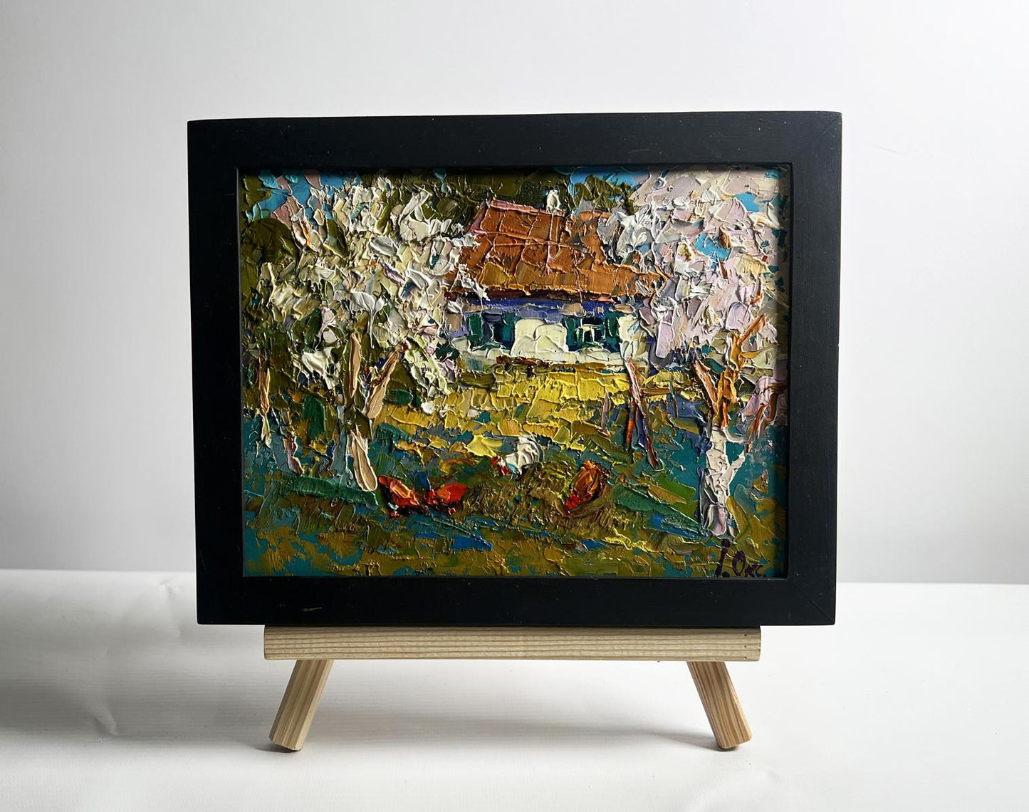 Oil painting of flowering trees in garden by Oksana Ivanyuk in black frame