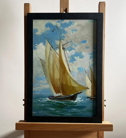 Framed oil painting of sailboats at sea by Yuriy Suprunchuk on wooden easel