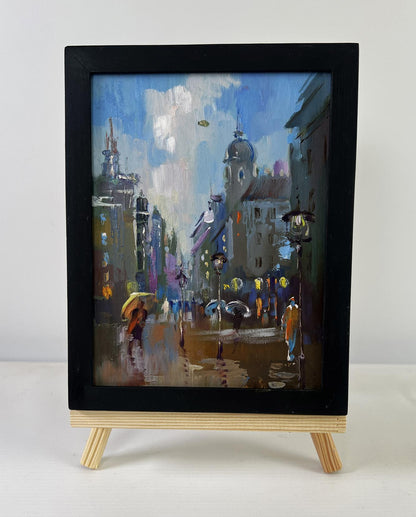 Framed impressionist oil painting of rainy city street by Yuriy Suprunchuk