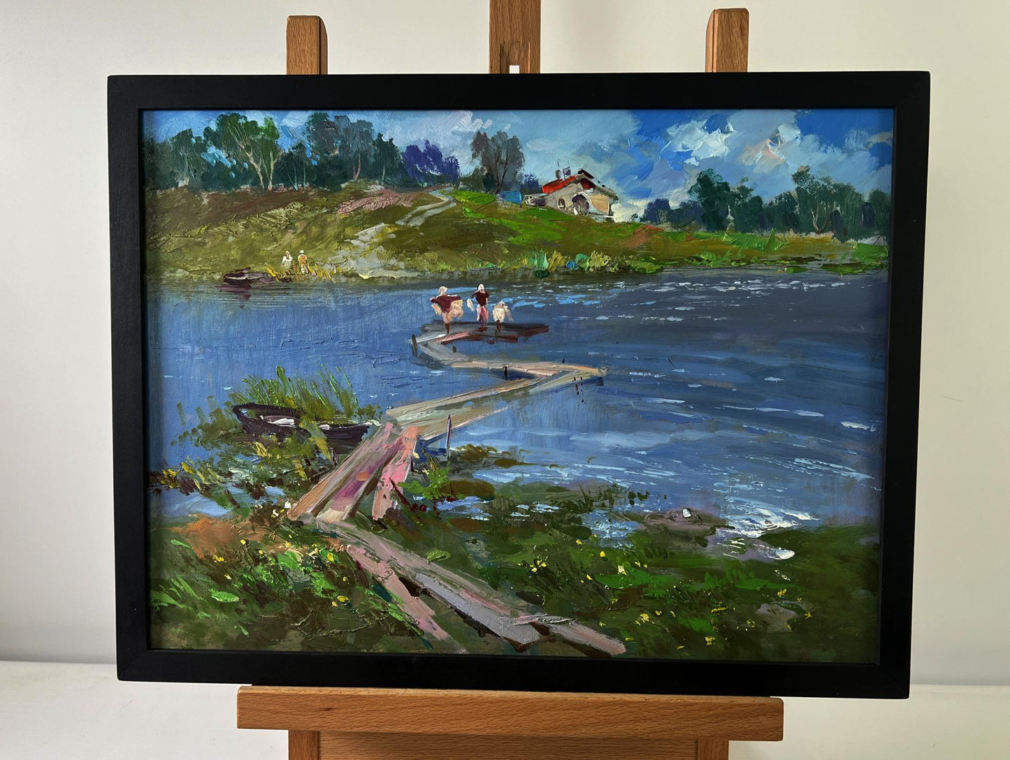 Framed oil painting by Yuriy Suprunchuk of riverside dock scene