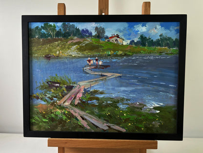 Framed oil painting by Yuriy Suprunchuk of riverside dock scene