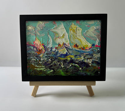 Oil painting of sailboats on turbulent seas by Oleksiy Ivanyuk in black frame