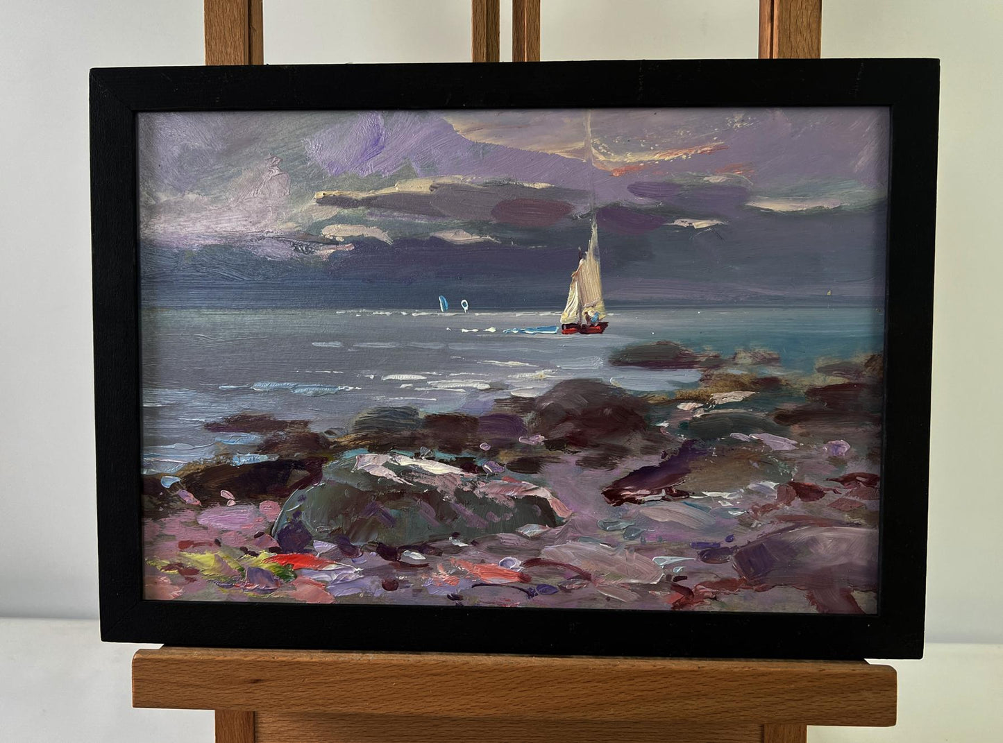 Framed oil painting of sailboat on turbulent blue waves by Yuriy Suprunchuk