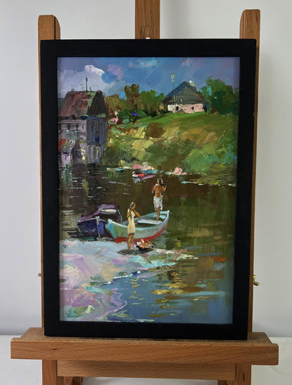 Oil painting of girls sailing in boat by Yuri Suprunchuk in black frame on easel