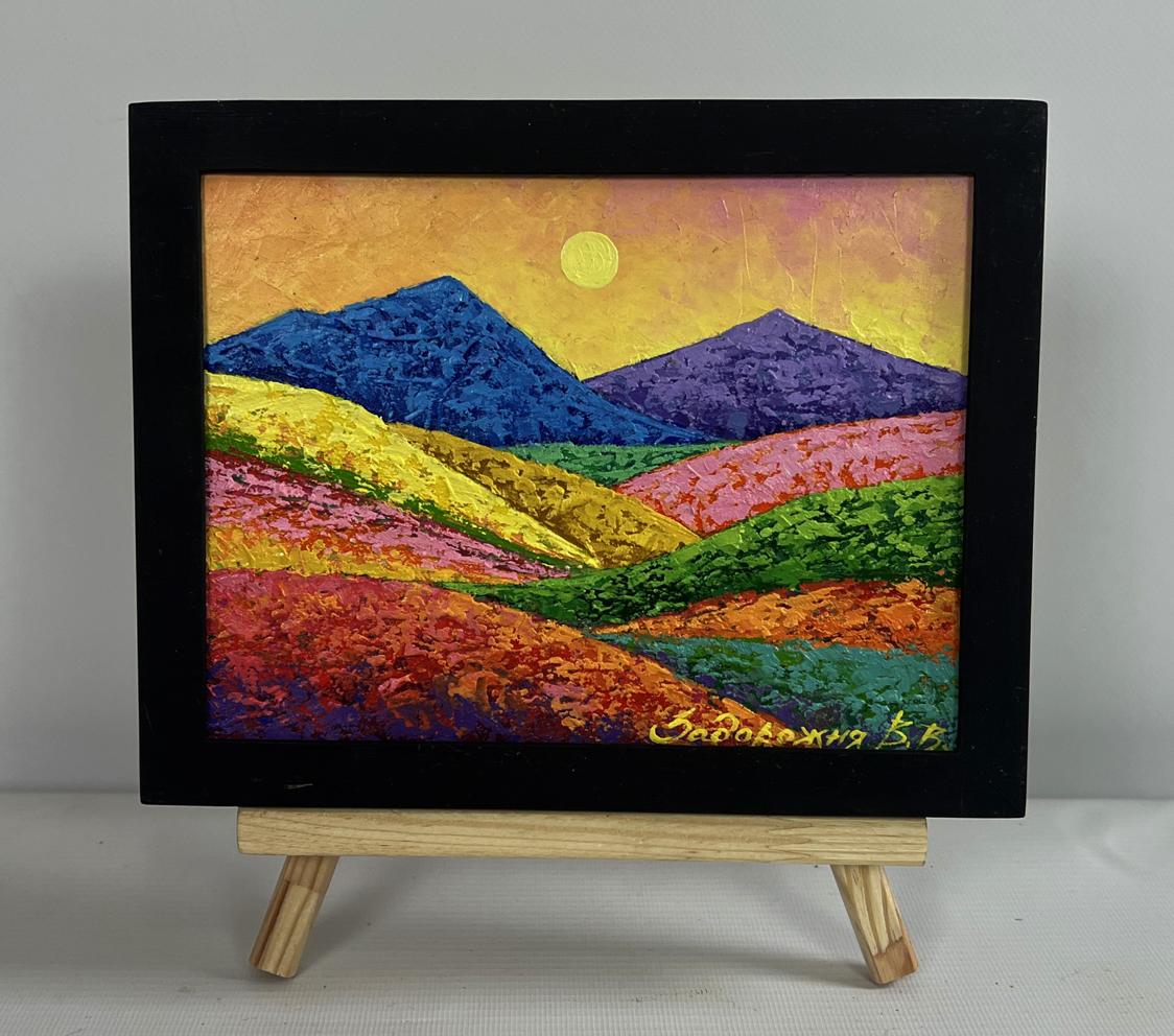 Oil painting of colorful meadow-covered mountains by V. Zadorozhnya in black frame