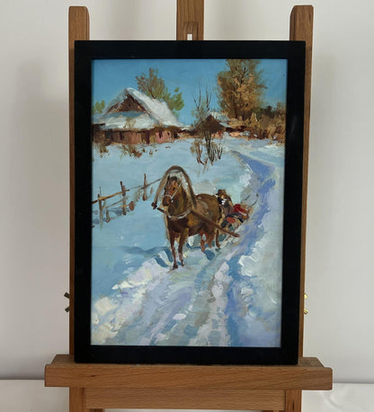 Framed oil painting of horse-drawn sleigh in snowy scene by Yuriy Suprunchuk